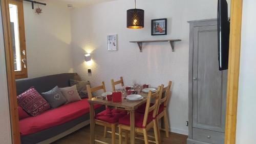un salon avec une table et un canapé dans l'établissement PARADISKI-BELLE PLAGNE, Altitude 2050m, APPART skis aux pieds 4 personnes, à La Plagne Tarentaise