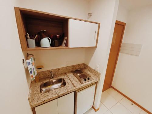 a kitchen with a sink and a counter top at Suíte completa no centro (SOHO Campos) in Campos dos Goytacazes