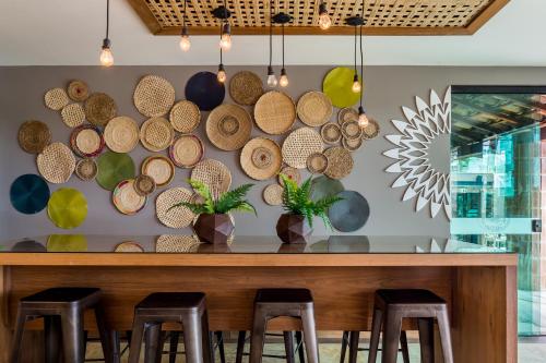 a bar with a bunch of hats on the wall at Bravo Pousada Design in Cabo Frio