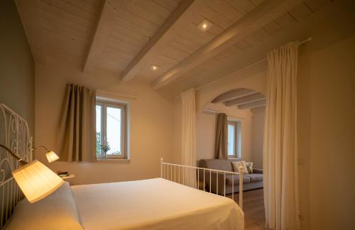 a bedroom with a bed and a living room at La Mascarana in Lesa