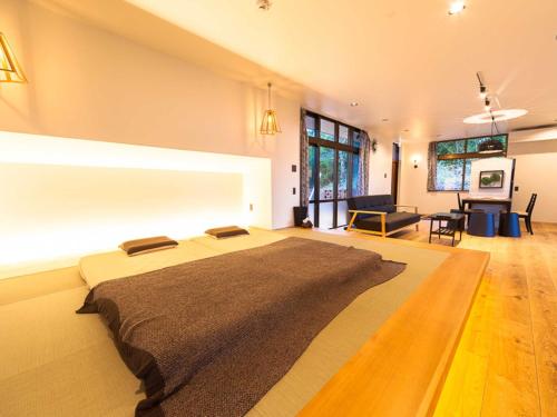 a bedroom with a large bed in a room at n-house - Vacation STAY 91411v in Nago
