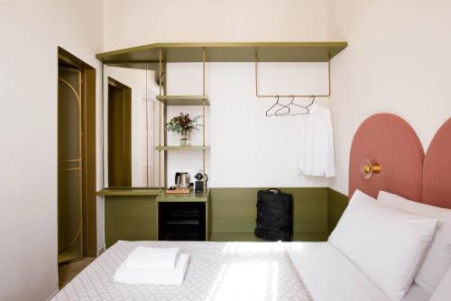 a bedroom with a bed and a desk with a lamp at Neratze Hammam Suites in Rethymno Town