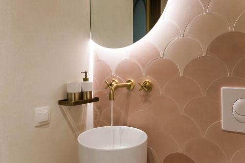 a bathroom with a sink and a mirror at Neratze Hammam Suites in Rethymno Town