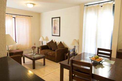 a living room with a table and a couch at Hotel Casa Divina Oaxaca in Oaxaca City