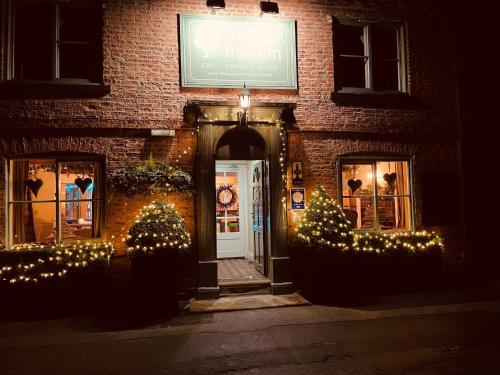 a building with christmas lights in front of it at Oak Tree Inn in Brafferton