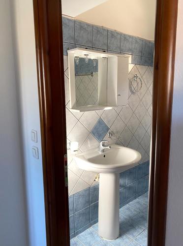 a bathroom with a sink and a mirror at Lithotomia Mouzaki in Mouzaki