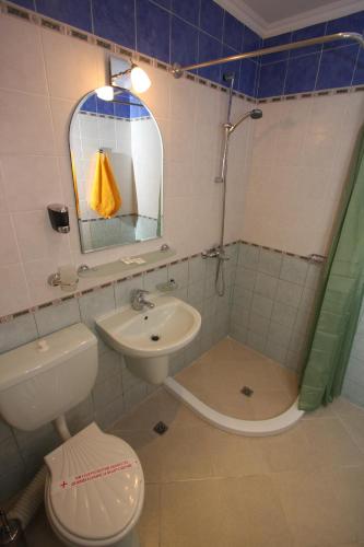 a bathroom with a sink and a toilet and a mirror at Tanya Hotel in Sunny Beach