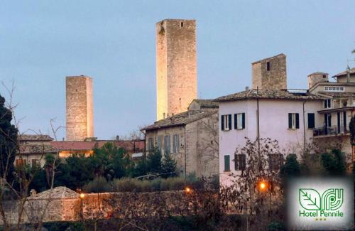 a building with two towers in the background at Hotel Pennile in Ascoli Piceno