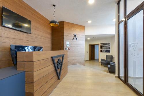 an office with a reception desk with a tv on a wall at Vidik Residence in Kopaonik