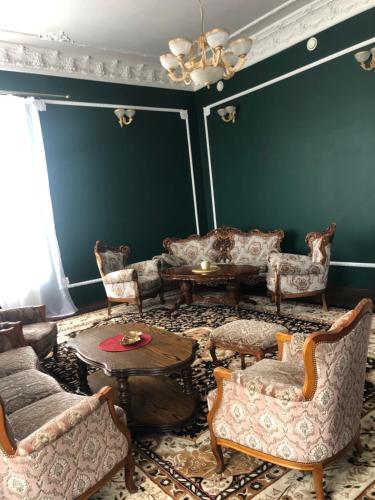 a living room filled with furniture and a table at PAŁAC FABRYKANTA in Myszków