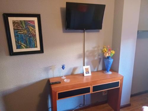 a table with a television on top of a wall at Coffee Cream Guest House Maia in Maia