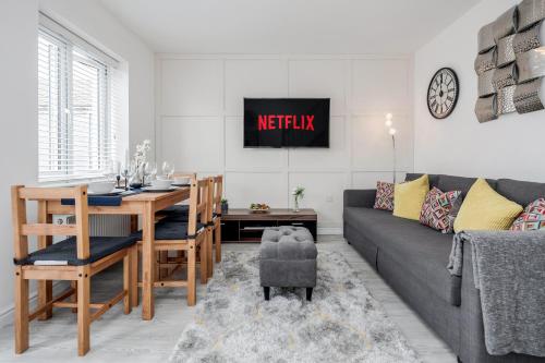 a living room with a couch and a dining room table at Dartford Kent Smart Nest in Dartford