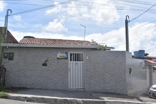 a small brick house with a white door at Recanto Novo Horizonte in Recife