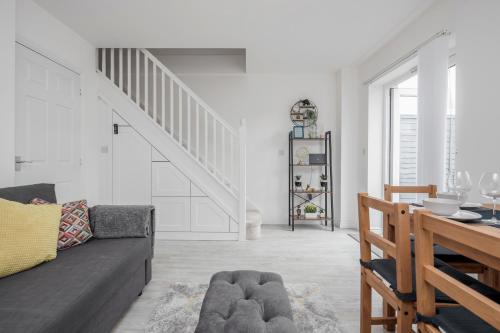 a living room with a couch and a staircase at Dartford Kent Smart Nest in Dartford
