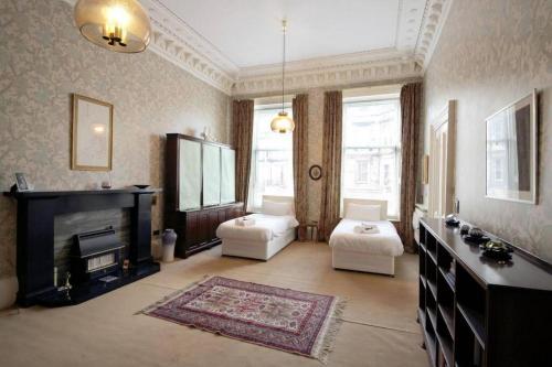 ein Wohnzimmer mit Kamin und ein Wohnzimmer mit Teppich in der Unterkunft Quirky, West End, Edinburgh House in Edinburgh