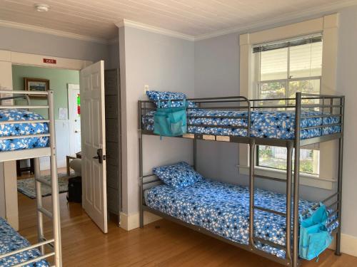 a room with three bunk beds and a window at Santa Cruz Hostel in Santa Cruz