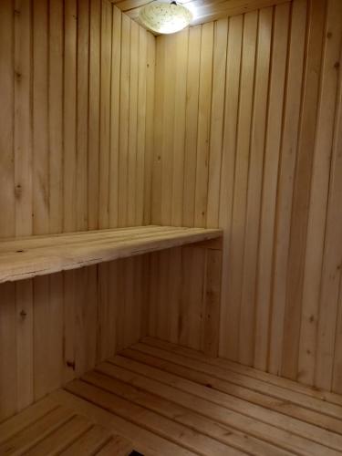 a wooden sauna with a wooden shelf in it at Три горішки in Yaremche
