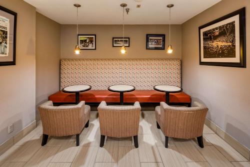 a dining room with four tables and chairs at SureStay Plus Hotel by Best Western Durham Medical Center in Durham