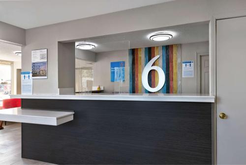 a lobby with a bar with the number six on it at Motel 6 McDonough, GA in McDonough