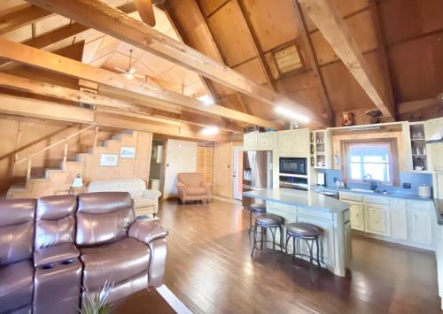 a kitchen and living room with a table and chairs at Blufftop Cabin Retreat Hot Tub and Fall Views! in Canadian