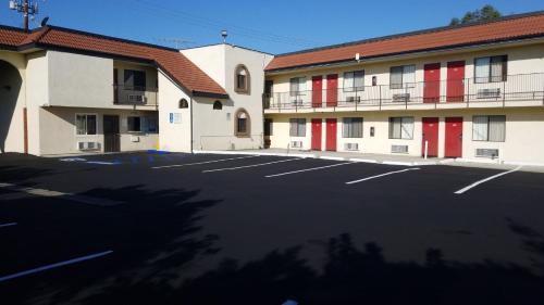an empty parking lot in front of a hotel at Royale Inn Motel in Whittier