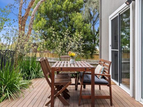 a wooden table and chairs on a patio at Point Roadknight Paradise Villa 6 in Anglesea