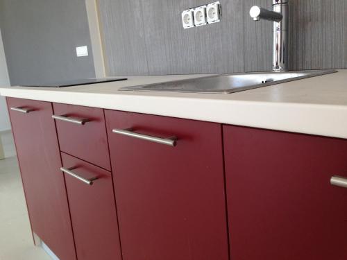 a bathroom with red cabinets and a sink at Apartments Exclusive Palace in Trogir