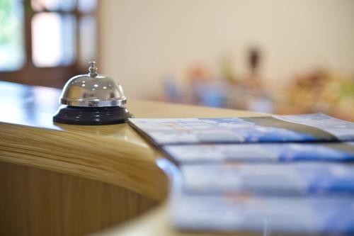a bell sitting on top of a table with a book at Mamaral in Agerola