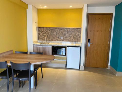 a kitchen with a table and chairs and a refrigerator at Resort Olimpia Apartamento in Olímpia