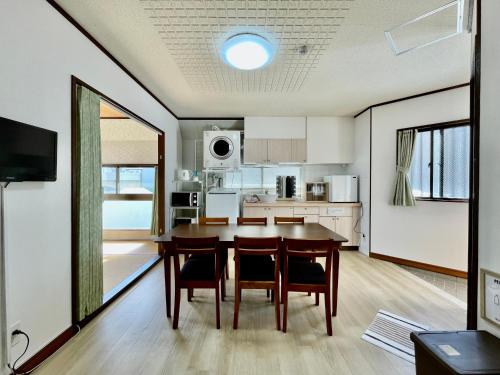 a kitchen and dining room with a table and chairs at West Villa in Naha