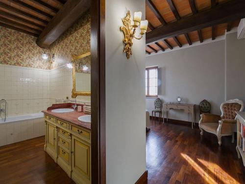 a bathroom with a tub and a sink and a mirror at Timeless Tuscan Holiday Stay in Arezzo