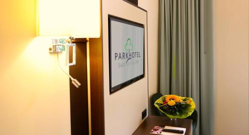 a hotel room with a sign on the wall at Parkhotel Bad Rehburg in Bad Rehburg