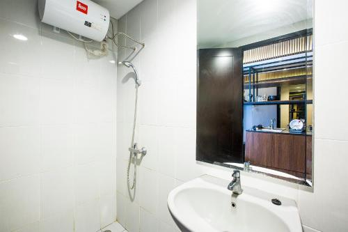 a bathroom with a sink and a mirror at Futura Studio-Modern Apartment near CBD BSD in Serpong