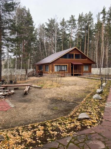 a log cabin in the middle of a forest at Forest and Lake in Borovoye