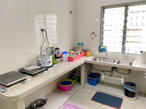 a kitchen with a sink and a counter top at Azzalea Terrace House @ Golden Hills Night Market Cameron Highlands in Brinchang