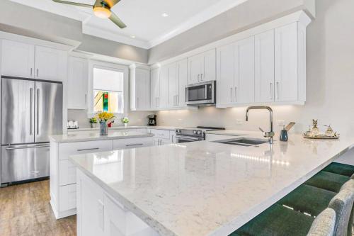 a kitchen with white cabinets and a white counter top at BrightWater Blue 158-2 in Clearwater Beach