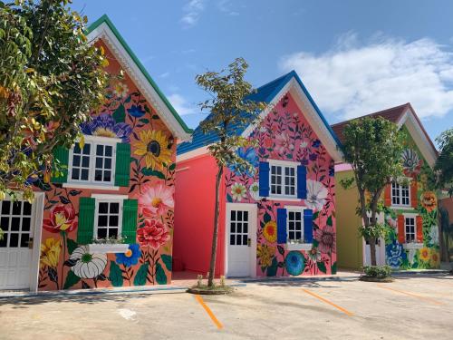 a row of houses painted with flowers at Mexican Resortlampang in Lampang