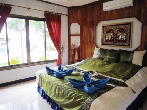 a bedroom with a bed with blue flowers on it at Moonwalk Lanta Resort in Ko Lanta