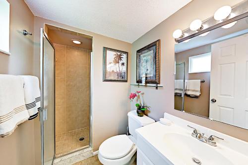 a bathroom with a shower and a toilet and a sink at Waves Unit 20 in St Pete Beach