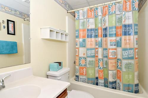 a bathroom with a toilet and a shower curtain at Sandpiper Dunes II in Ocean City