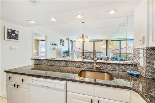 a kitchen with a sink and a living room at Sea Watch Condos VI in Ocean City