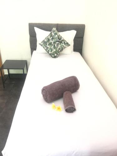a bed with a stuffed animal on top of it at Le Chien Rouge in Lovina