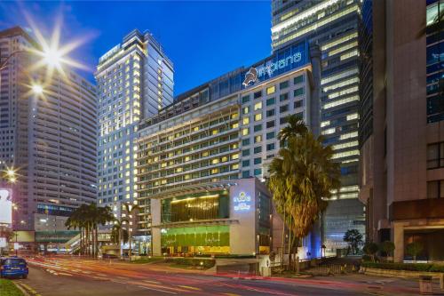 a city street with tall buildings at night at Impiana KLCC Hotel in Kuala Lumpur