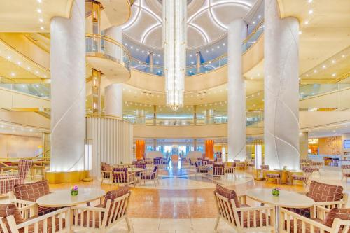 a lobby with tables and chairs in a building at Swissotel Nankai Osaka in Osaka