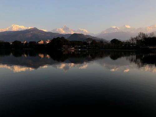 a view of a lake with mountains in the background at Hotel Yeti in Pokhara
