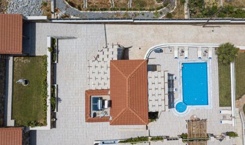 an overhead view of a building with a swimming pool at Agapi Villas I & II, Seaside Retreats with Pool & BBQ, By ThinkVilla in Panormos Rethymno