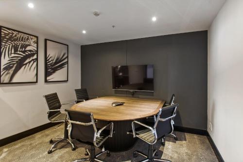 a meeting room with a wooden table and chairs at The Capital Zimbali in Ballito