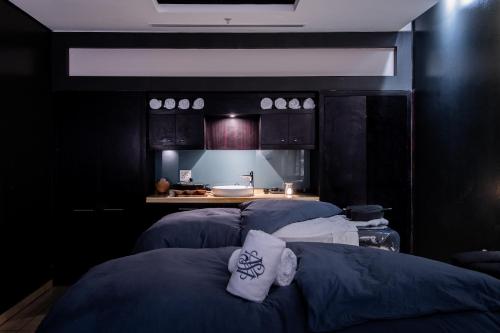 a kitchen with three blue beds in a room at The Capital Zimbali in Ballito