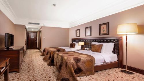 a hotel room with two beds and a television at Crowne Plaza Istanbul Asia by IHG in Istanbul