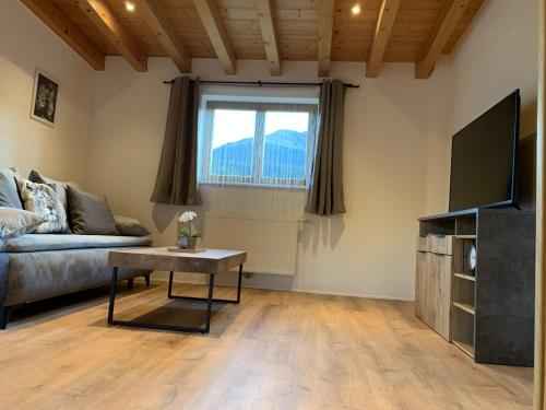 salon z kanapą i stołem w obiekcie Ferienwohnungen Pletzenauer w mieście Sankt Johann in Tirol